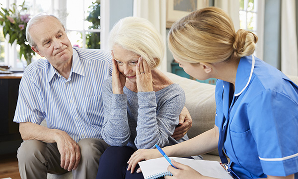 community nurse visits senior woman suffering with depression
